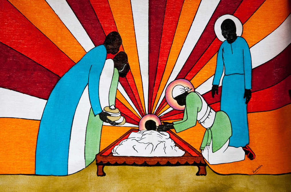 Das Motiv "Afrikanische Batik" von David Keith Jones: Das Jesuskind in der Krippe, daneben Maria und Josef und die Heiligen Drei Könige